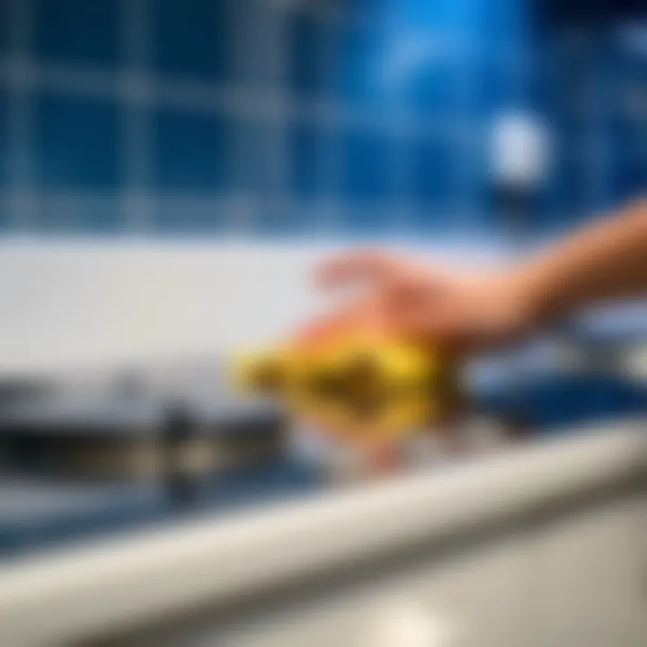 Close-up of a white glass stove being cleaned with a microfiber cloth.
