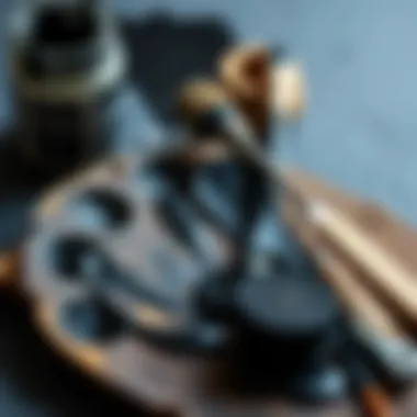 Palette with black paint and mixing tools