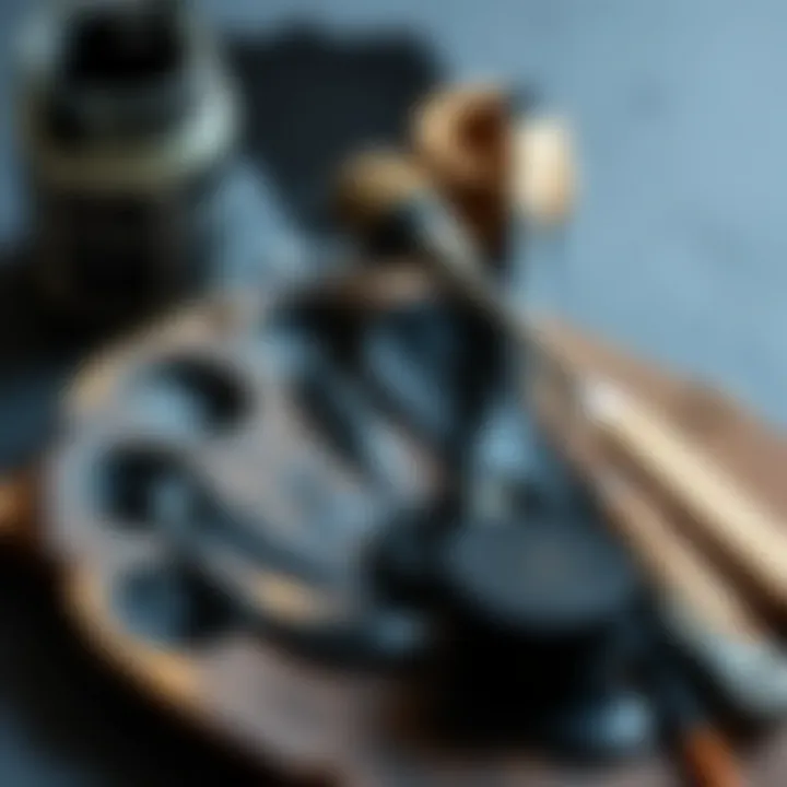 Palette with black paint and mixing tools