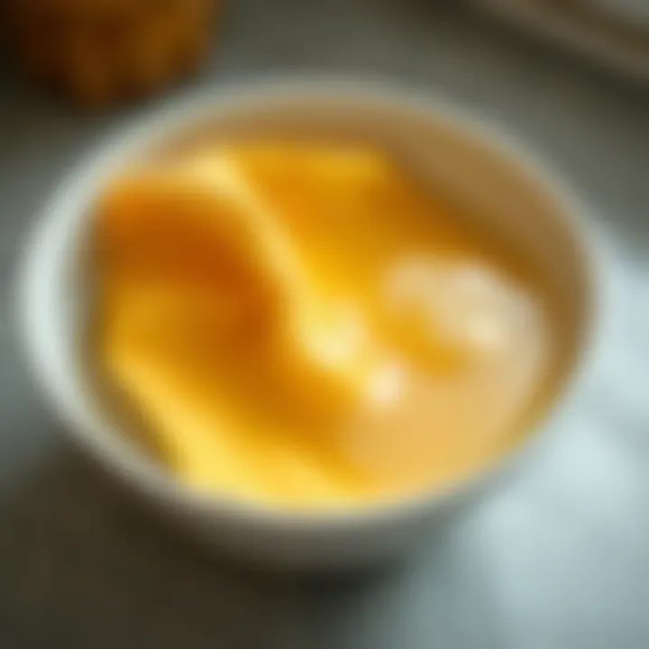 A close-up of a kitchen cloth being soaked in a bowl of soapy water.